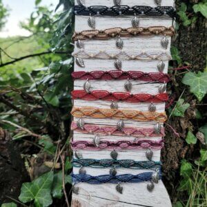 Bracelet de cheville de différentes couleurs avec des breloques en forme de feuille.